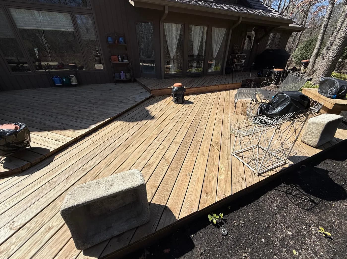The same deck after washing, the boards back to a warm natural wood color.